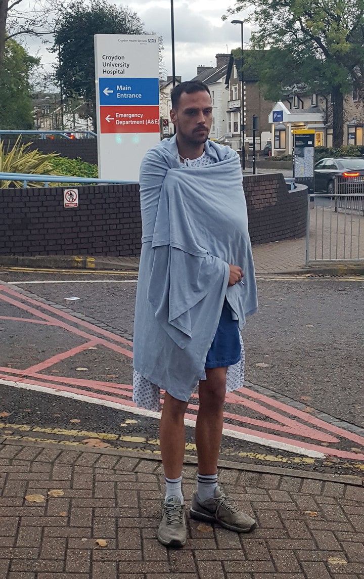 Martin Bamford, 30, stands outside Croydon University Hospital where he is being treated for fractured or broken ribs