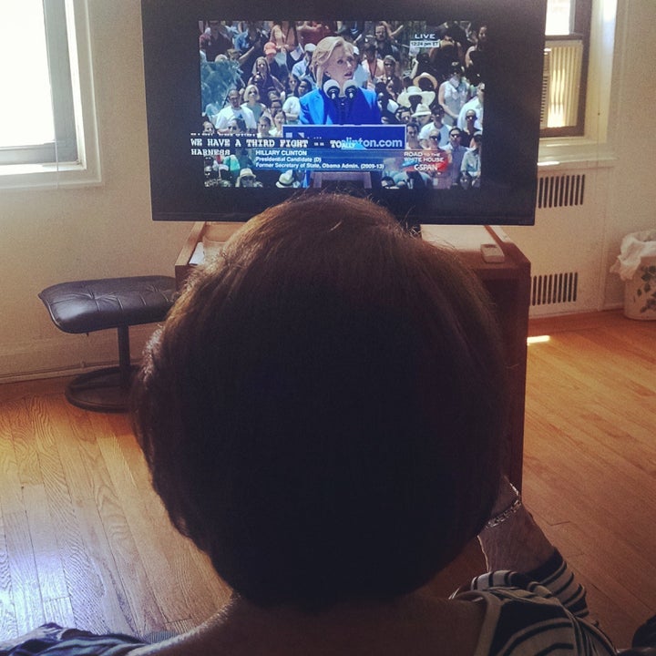 The author's grandmother watches Hillary Clinton's campaign launch, April 2015.