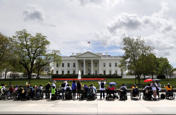 Protesters with ADAPT, a disabled people's rights organization, stage a demonstration at the gates of the White House on April 20, 2015.