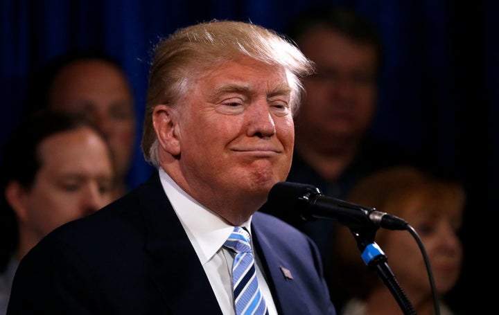 President-elect Donald Trump smiles as he stands with 22 delegates to the Republican National Convention from North Dakota on May 26, 2016.