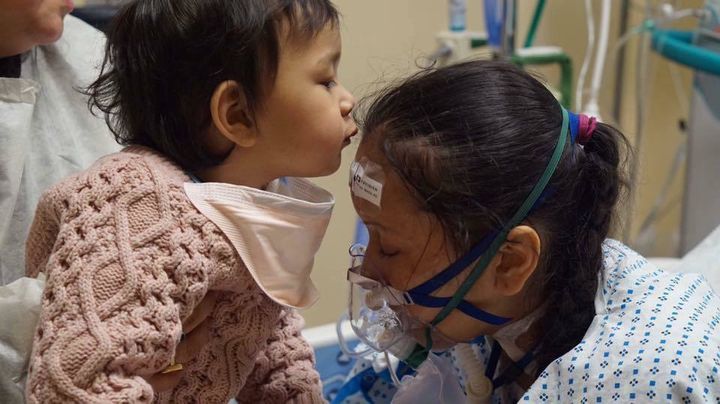One day after delivering her child, Prasha Tuladhar’s lungs failed. Here, Prasha’s healthy daughter kisses her forehead.