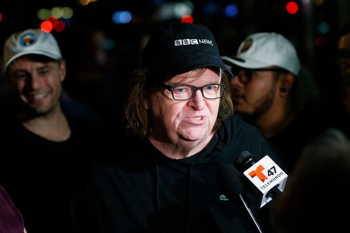 US filmmaker Michael Moore speaks with members of the media as he arrives at the IFC Theater before the debut of a surprise documentary about Republican presidential nominee Donald Trump titled 'TrumpLand' in New York on October 18, 2016.