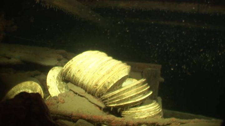 Piles of plates are seen inside of the ship's galley.