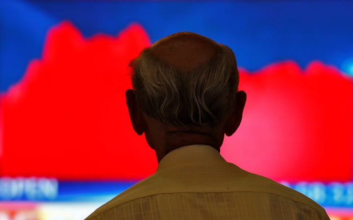 A guy looking at a screen.