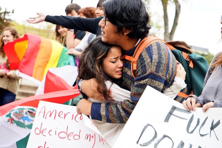 <p>Student Huriel Perez hugging another student during the public forum </p>