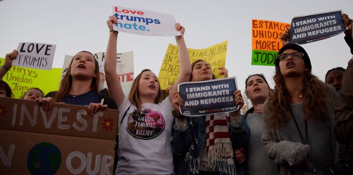 Anti President-elect Donald Trump protesters chant outside the White House in Washington, DC.