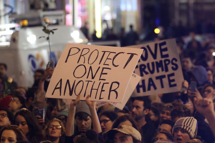 New York: A protestor holds a sign calling for people to 'protect one another'