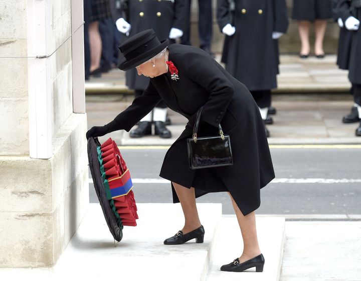The Queen lays a wreath of poppies at the foot of the Cenotaph in London