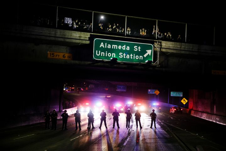<strong>Los Angeles: Police officers stand guard as they slowly clear anti-Trump protesters off the 101 freeway</strong>