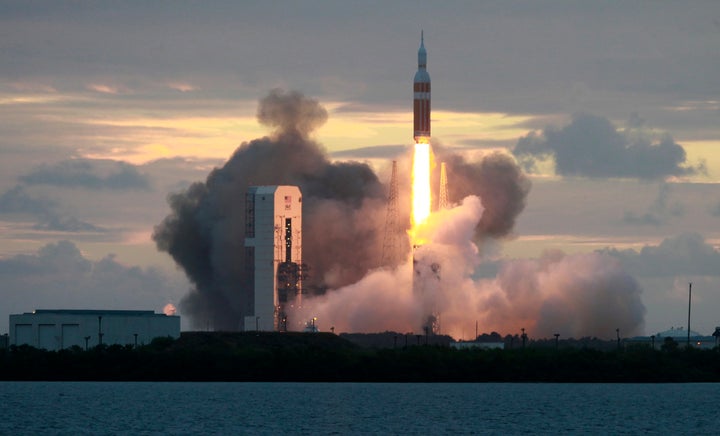 The Delta IV Heavy rocket with the Orion spacecraft lifts off from the Cape Canaveral Air Force Station in Cape Canaveral, Fl