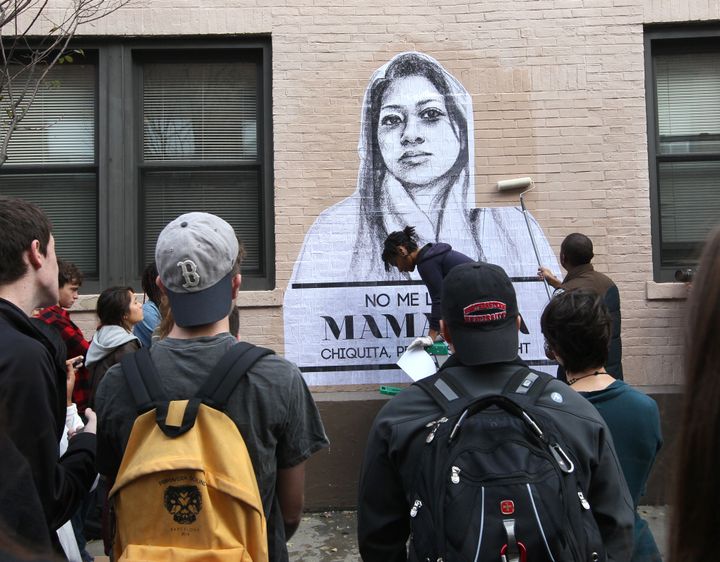 Artist Tatyana Fazlalizadeh draws a crowd as she installs a wheat-pasting project message, "Stop Telling Women to Smile," on a Northeastern University building. According to Northeastern, the portraits of women speak to the gender-based street harassment that many women face daily and gives them the outlet to speak back to their harassers.