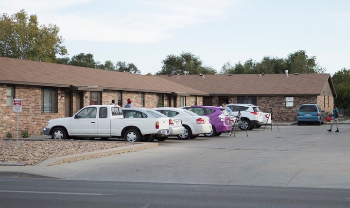 People stand outside an Islamic mosque located within an apartment complex, which federal authorities allege was to be targeted in a bomb plot by three Kansas men. October 14, 2016.