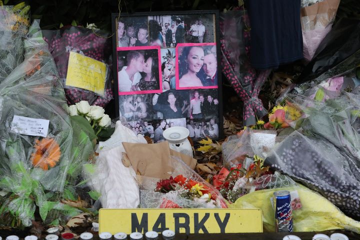 Floral tributes and photographs left near the scene where a tram crashed, killing seven people, in Croydon, south London.