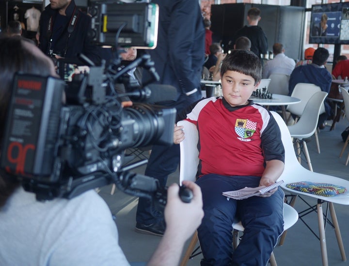 <p>A young chess fan is interviewed by Russian media</p>
