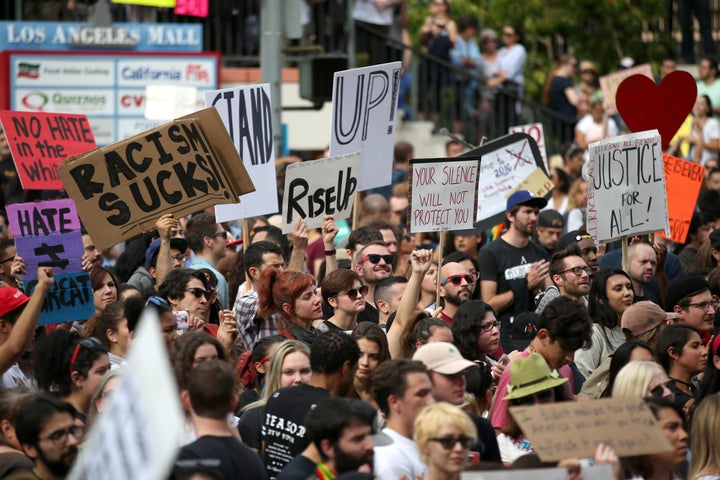 People gather outside a federal building during a march and rally against the election of Republican Donald Trump as President of the United States in Los Angeles, California, U.S. November 12, 2016.