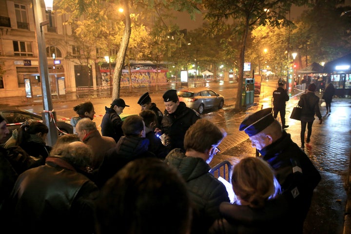 Policemen search concert goers outside Le Bataclan Concert Hall on Nov.12, 2016, in Paris.