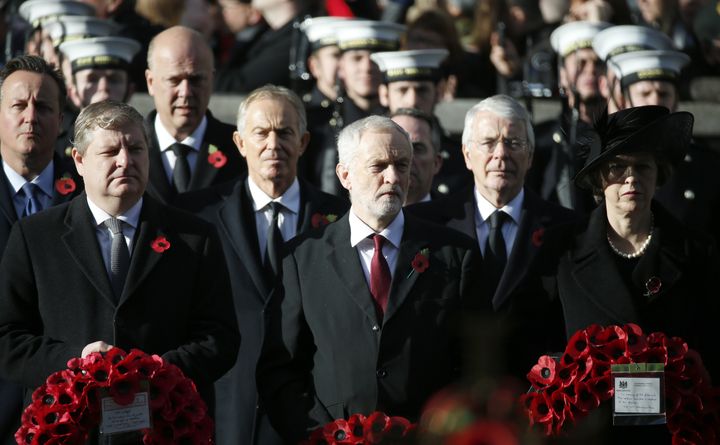 Britain's Prime Minister Theresa May, right, and the Leader of the Opposition Labour party Jeremy Corbyn, center, stand in front of former Prime Ministers John Major, second right, Tony Blair, center left, and David Cameron, left, during the Remembrance Sunday service.
