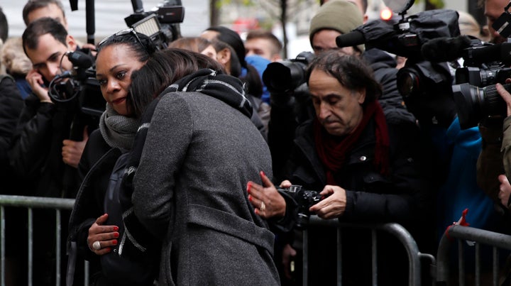 Relatives of the victims gather next to a commemorative plaque in front of the Bataclan concert hall in Paris.