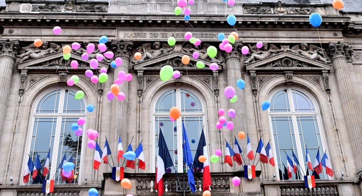 French people release balloons during the first anniversary of the Paris terror attacks in front of the city hall of the 11th arrondissement.