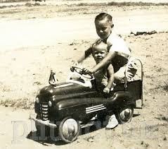 Vintage photo of a child in his toy car 