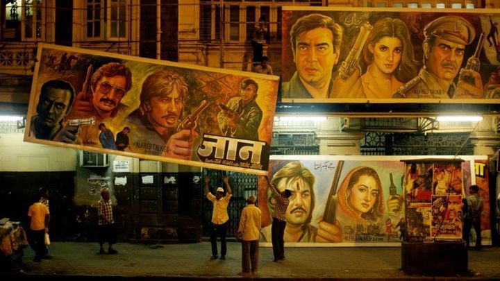 Sheik Rehman and his crew changing billboards in front of the Alfred Talkies movie theatre in a scene from Original Copy 