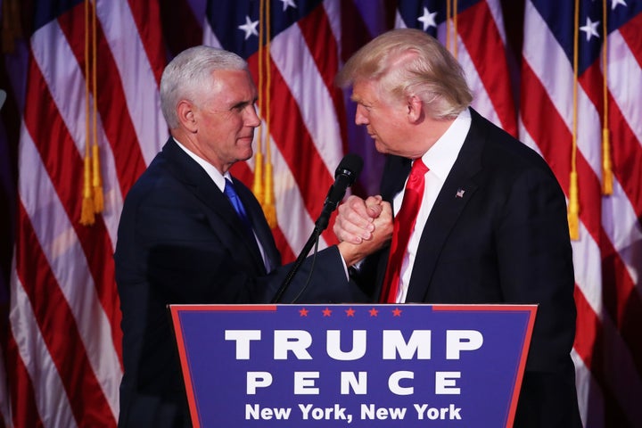 Vice president-elect Mike Pence and Republican president-elect Donald Trump shake hands during his election night event in New York City. 