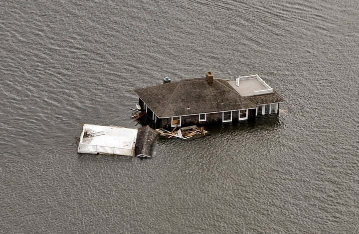 This photograph shows a house floating in the bay after it was washed from its foundation in Manotoloking, New Jersey, during Hurricane Sandy in October 2012.