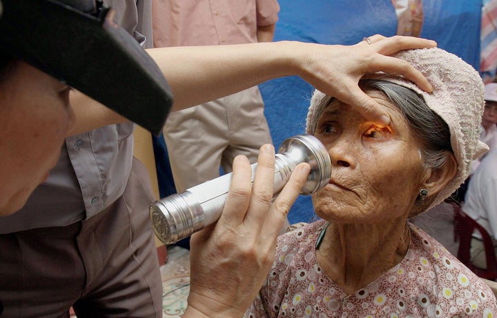 An elderly woman receives an eye examination for trachoma in Hiep Hoa village, in Thai Binh, Vietnam, July 6, 2005.