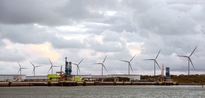 Wind turbines behind gates of LNG Terminal at Maastvlatke, Port of Rotterdam.