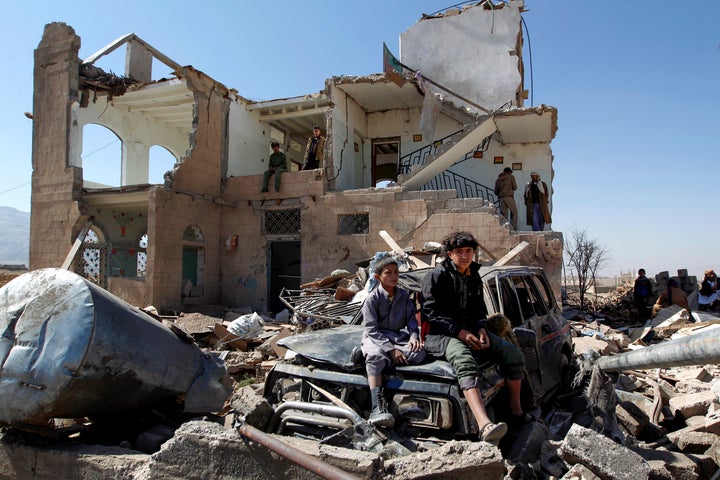 Children sit amidst the rubble of a house hit by Saudi-led coalition air strikes two days earlier on the outskirts of the Yemeni capital Sanaa on November 14, 2016.