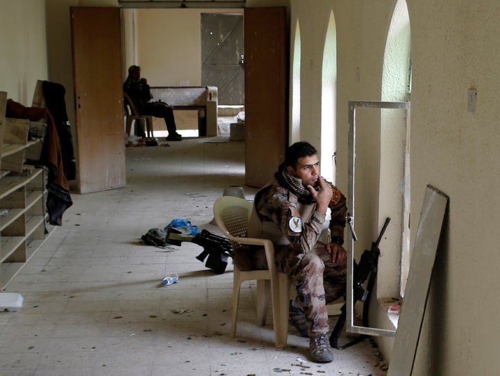 An Iraqi special forces soldier smokes while seated in his position inside a mosque in Mosul, Iraq, November 15, 2016.