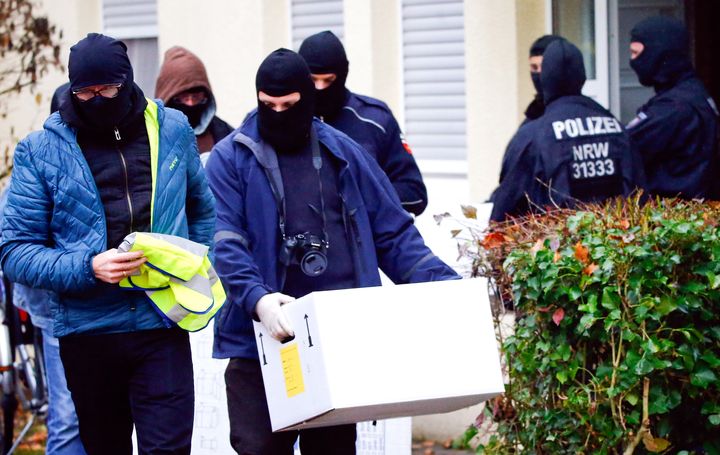 German special police leave a house in Bonn November 15, 2016. German police launched dawn raids on mosques, apartments and offices in ten German states.