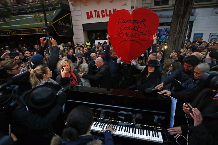 <strong>People pay their respects to those killed at the Bataclan concert hall in Paris a year after the tragedy</strong>