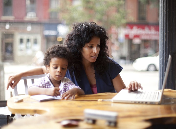 Mother and son working at cafe. Ben Bloom via Getty Images