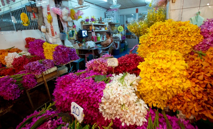 A Thai flower vendor watches a soap opera on television at his shop in Bangkok. Anger is growing against the country's soap o