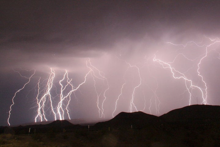 A long-exposure photograph shows lightning bolts illuminating the night sky north of Barstow, California, in 2015.
