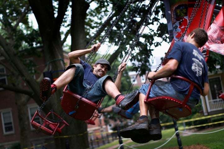 <p>Workers ride a 19th-century swing in New York.</p>