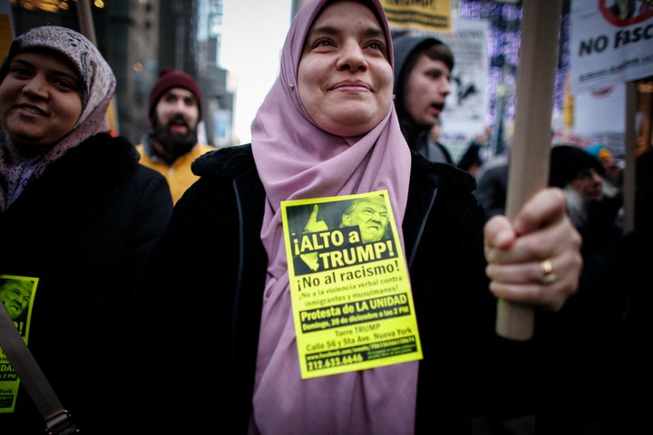 A Muslim woman holds a poster during a protest against Donald Trump on December 20, 2015 in New York.