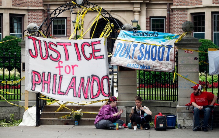 Banners block the entrance gate as demonstrators gather outside the governor's residence, July 8, 2016, in St. Paul, Minnesota, where protests continue over the shooting death by police of Philando Castile after a July 6 traffic stop in Falcon Heights.