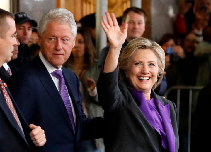 Hillary Clinton departs with her husband, former U.S. President Bill Clinton, after addressing her staff and supporters about