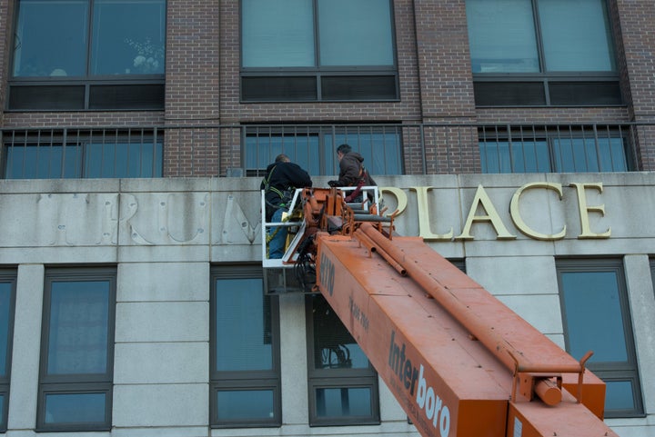 Workers remove Trump signage from 180 Riverside Blvd. on Manhattan's Upper West Side.