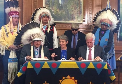 Blackfeet Nation Chairman Harry Barnes, left, Secretary of the Interior Sally Jewell and Devon Energy CEO David Hager gather with other tribal leaders in Washington to officially cancel the 15 leases.