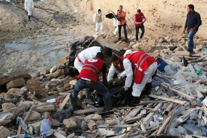 Members of the Libyan Red Crescent treat the drowned bodies of migrants which washed ashore