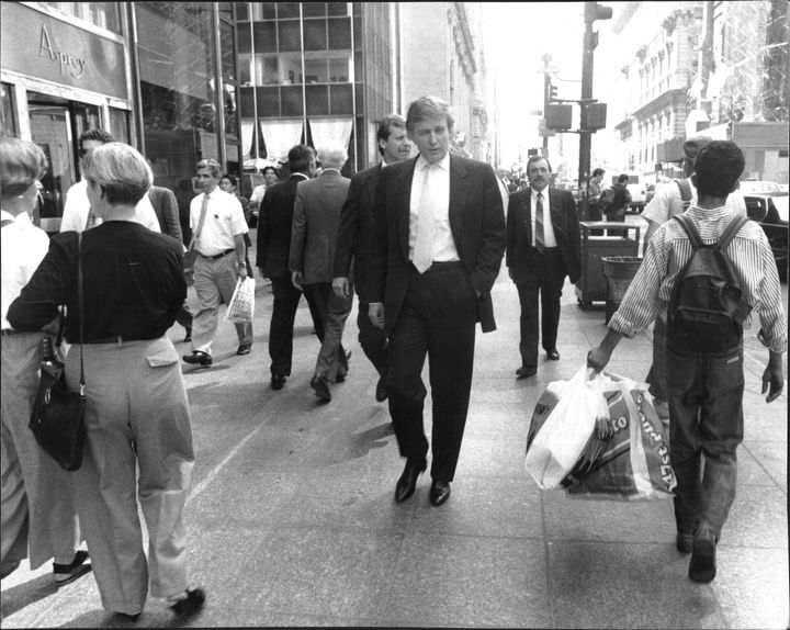 Walking down Fifth Avenue, Donald Trump goes unnoticed by sidewalk crowds during lunchtime on August 28, 1990.