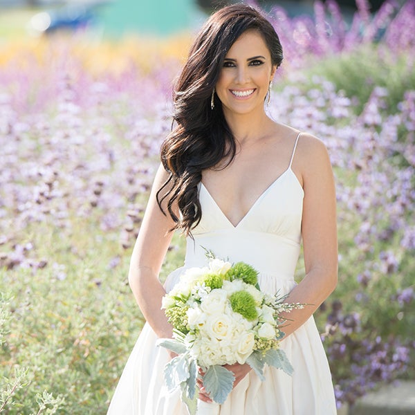 Recreate this bride's effortlessly elegant wedding look by making a deep side part, curling your hair into loose waves, and arranging them off to one side.Related: Gorgeous Ways To Wear Your Hair Down For Your Wedding