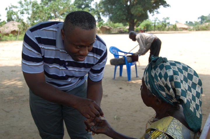 Dr. Wilfried Mutombo consults with a patient with sleeping sickness. Because some of the stage-one sleeping sickness symptoms