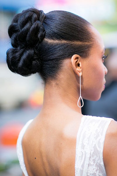 Blessed with thick hair? Ask your hairstylist for not one, but two smaller buns that they can expertly weave together for a modern coif.