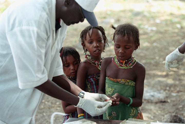 Nomads from the Peul tribe give blood samples to be tested for sleeping sickness, part of an ambitious campaign set up by the