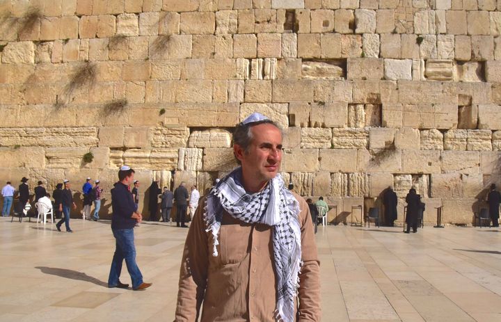 Me at the Western wall in Jerusalem, with a Jewish yamaka and an Arabic kaffiyeh.