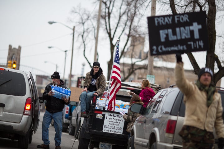 Protestors hand out water to Flint residents during a rally in January.